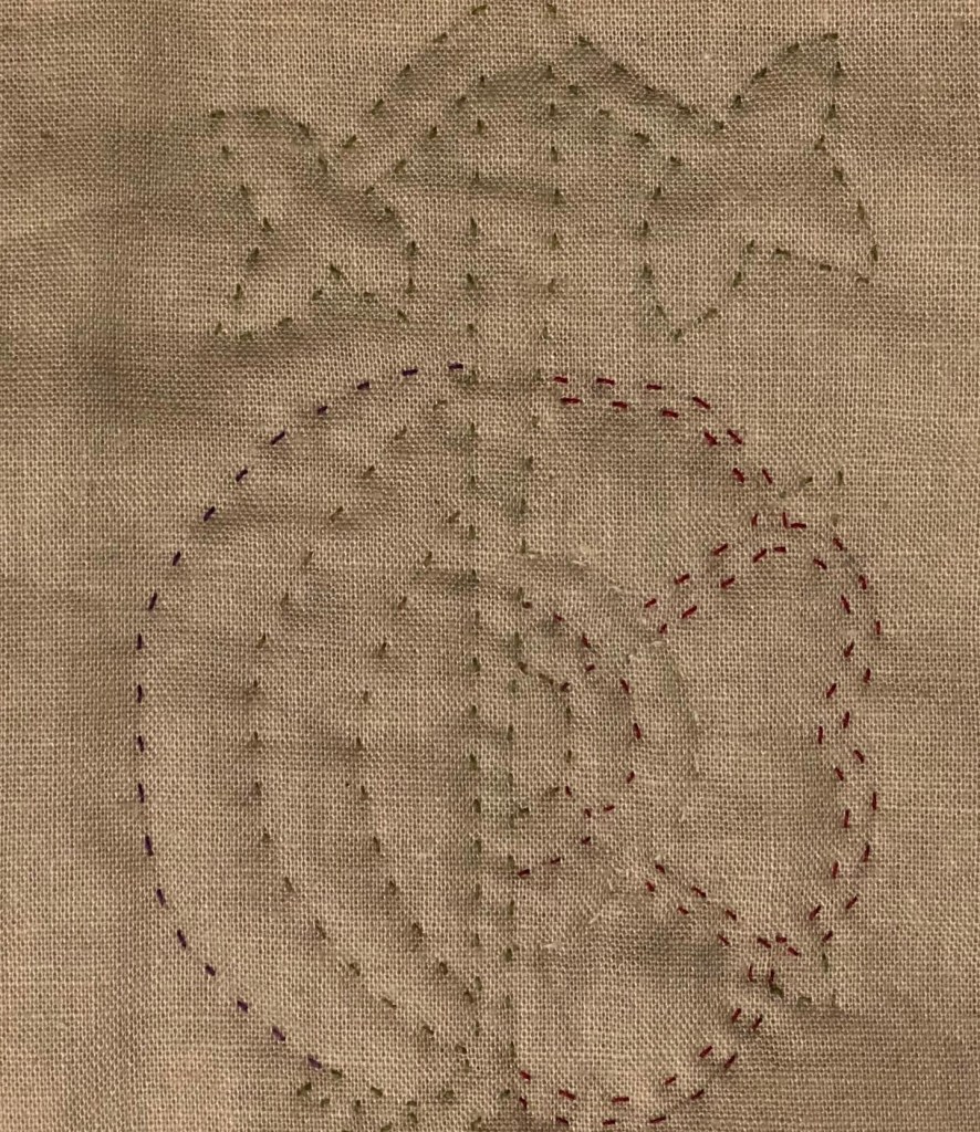 The stitched rose and pomegranate motif again, this time the “wrong” way up with the leaves and stem at the top of the motif.