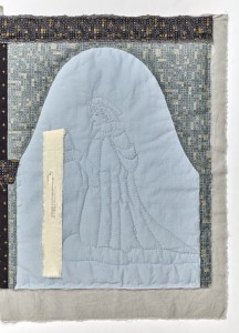 A quilted picture of Christophe Cremuel, kneeling under an arch and holding a book. A strip of fabric with text attached falls from the book. 